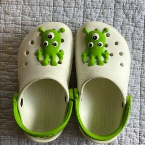CROCS White and Green Monster shoes.